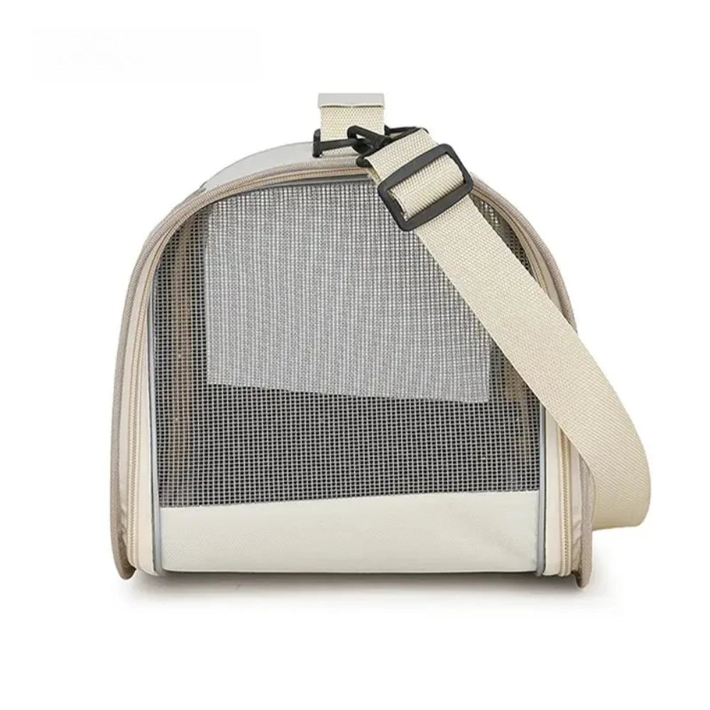 Beige pet carrier bag with a crossbody shoulder strap and mesh side panel