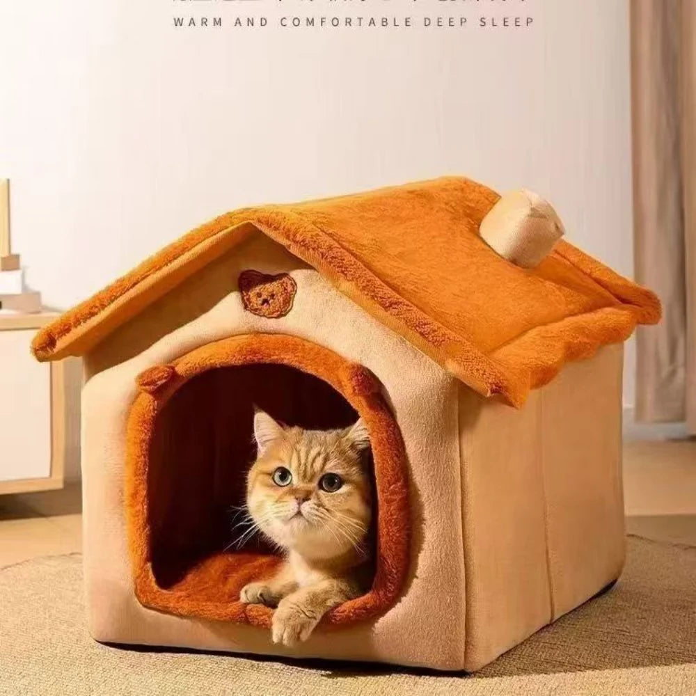 Cat looking out from an orange-brown house-style pet bed